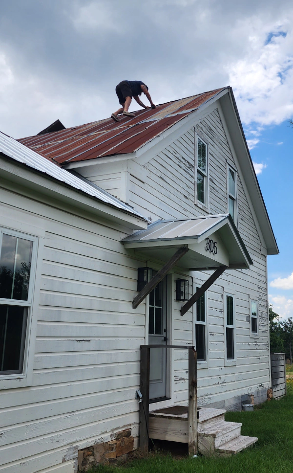 contractor doing a roof replacement during a house remodeling