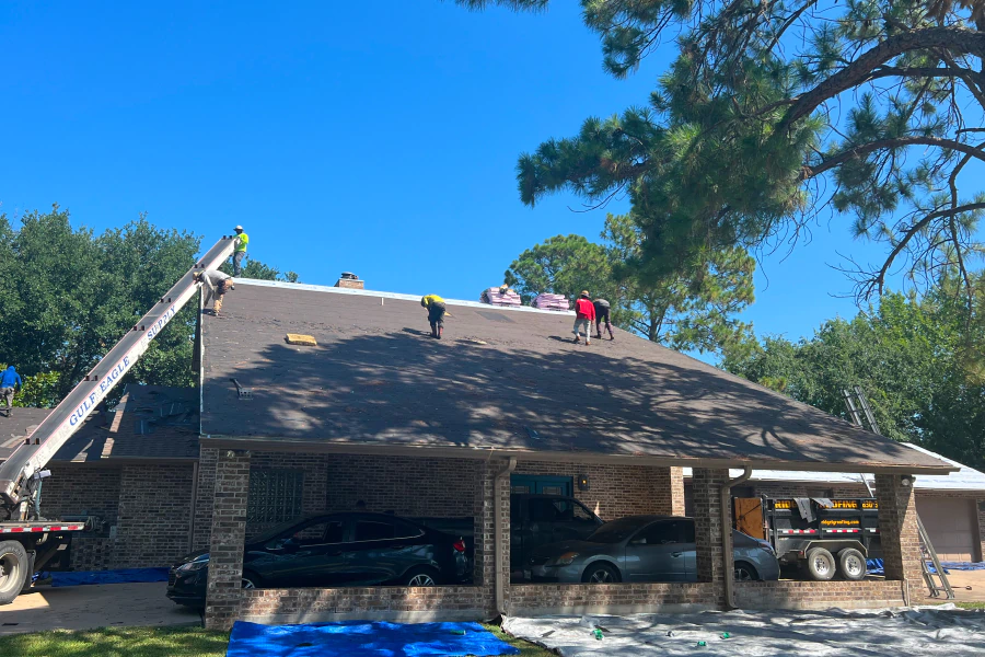 contractors working on a shingle roof installation