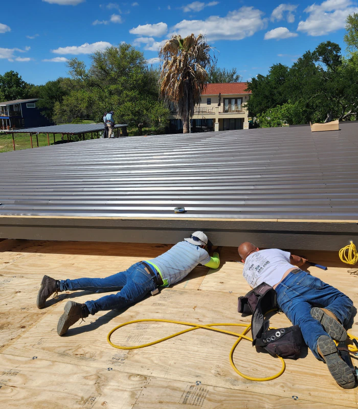 roofers doing a metal roofing installation