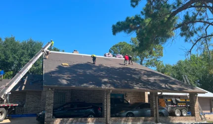 contractors working on a shingle roof installation